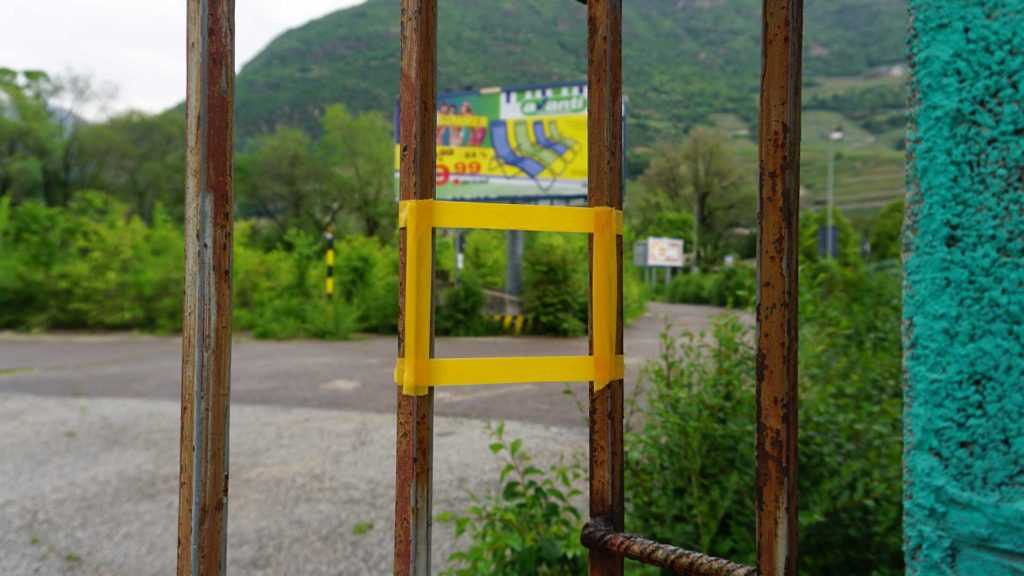 picture of a single orange frame taped onto the gate of the area
